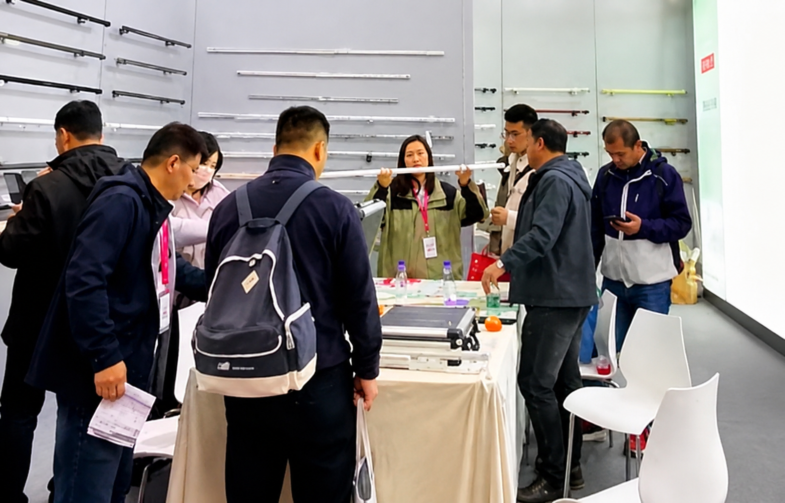 Visitors discussing curtain tracks at a FEIYANG display